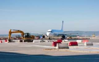 Airplane with construction equipment on runway