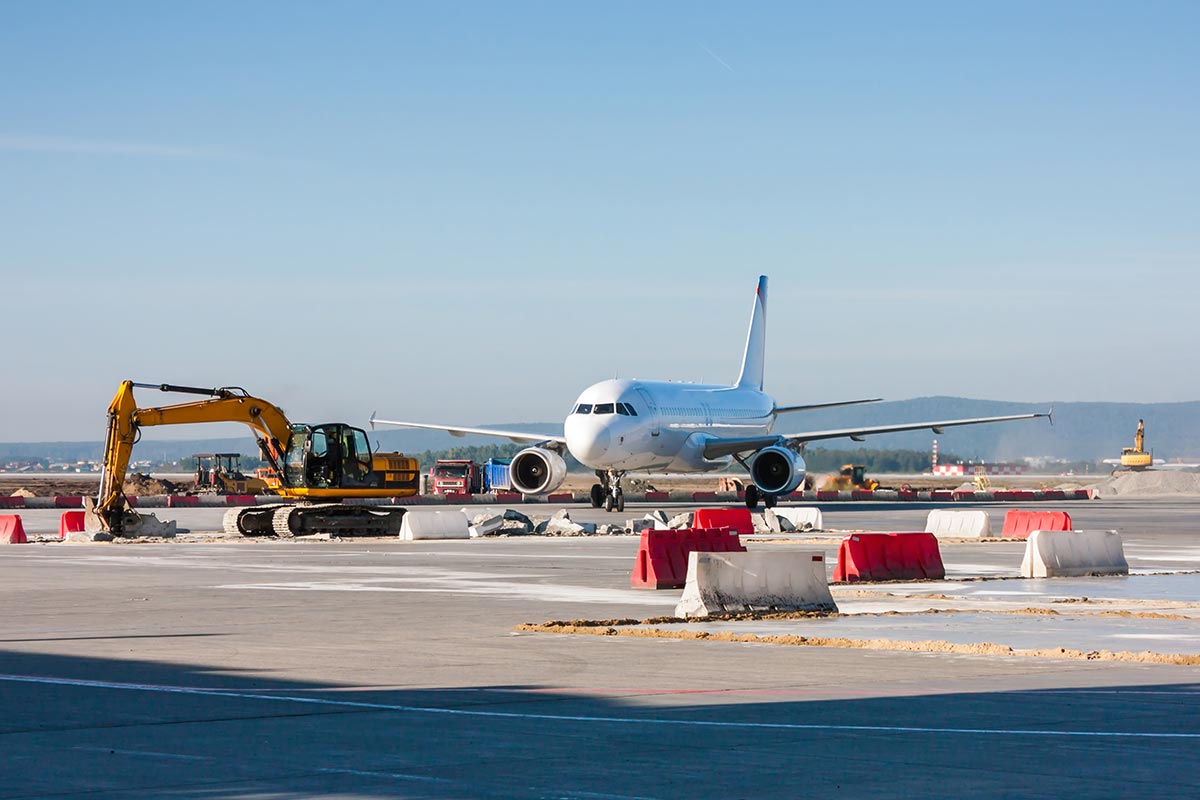 Airplane with construction equipment on runway