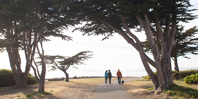 family walking dog on path