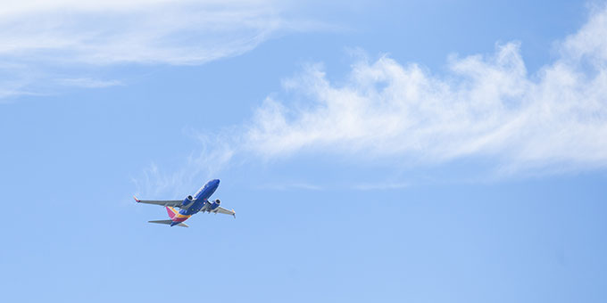 airplane flying through blue sky