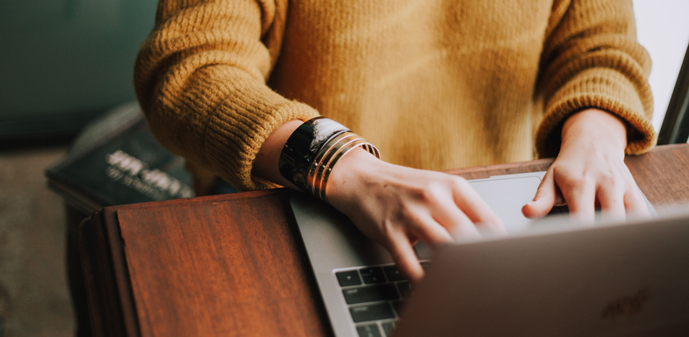 woman typing on laptop